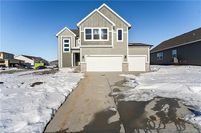 316 Woodview Dr, Raymore, MO 64083 - view of front facade featuring an attached garage, concrete driveway, and board and batten siding