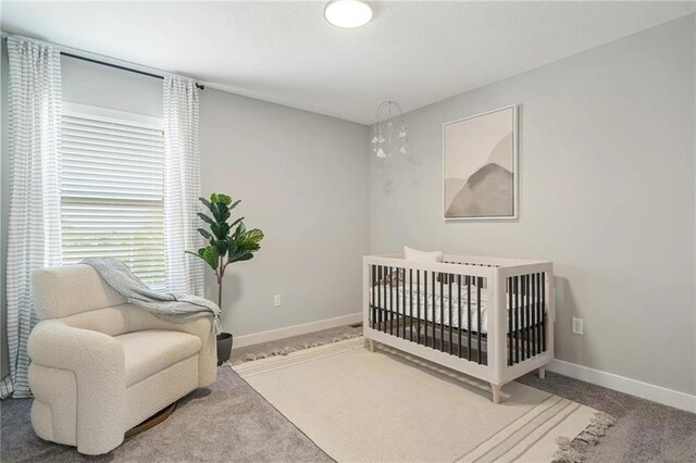 19720 W 195th Pl, Spring Hill, KS 66083 - carpeted bedroom with baseboards and a crib