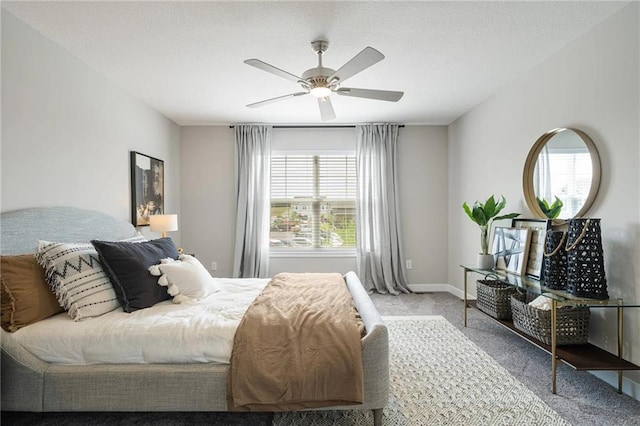 carpeted bedroom with multiple windows and ceiling fan