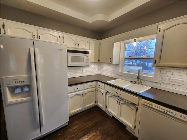 kitchen featuring white cabinets, white appliances, dark wood-type flooring, and sink