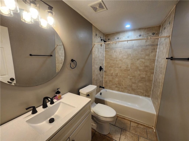 full bathroom with vanity, tiled shower / bath combo, and toilet