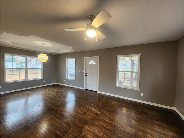 entryway featuring a raised ceiling, ceiling fan, and dark hardwood / wood-style floors