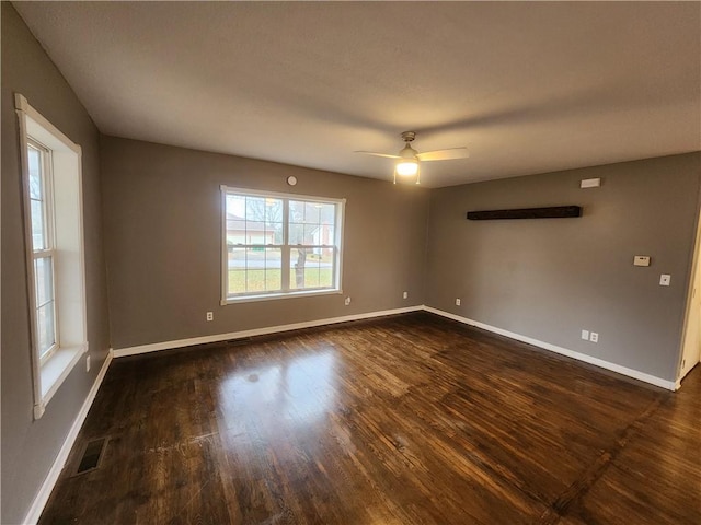 spare room featuring dark hardwood / wood-style flooring and ceiling fan