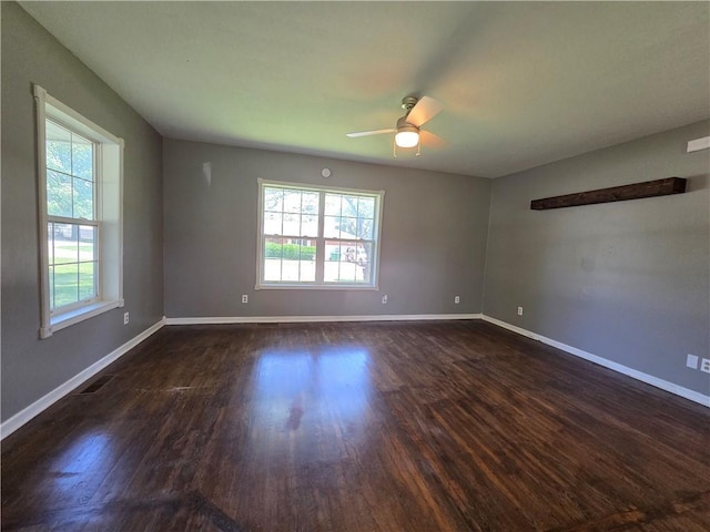 909 N Fulton St, Butler, MO 64730 - spare room featuring dark wood finished floors and ceiling fan