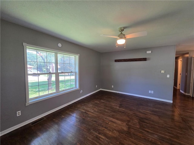 909 N Fulton St, Butler, MO 64730 - unfurnished room with dark wood-style flooring and ceiling fan