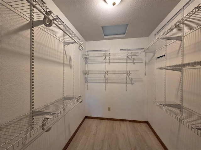 909 N Fulton St, Butler, MO 64730 - spacious closet featuring light wood finished floors