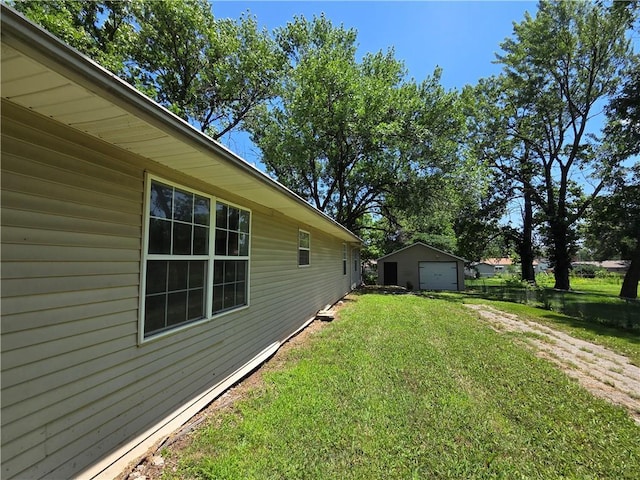 909 N Fulton St, Butler, MO 64730 - view of grassy yard featuring a garage