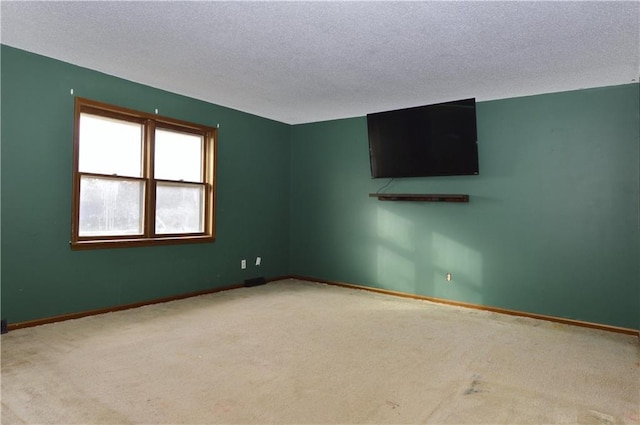 carpeted spare room with a textured ceiling