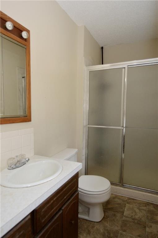 bathroom with vanity, toilet, and walk in shower