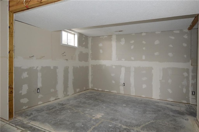 basement featuring a textured ceiling