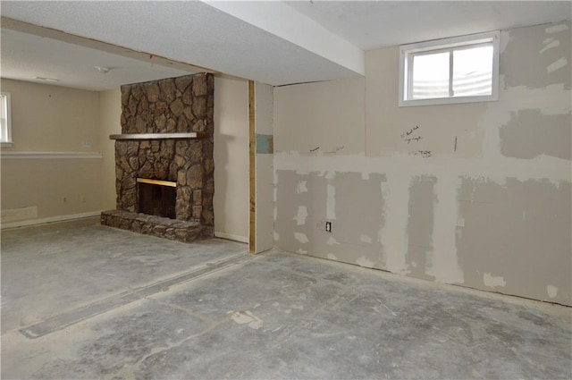 basement featuring a stone fireplace