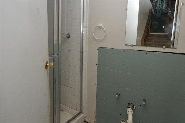 bathroom with a shower with door