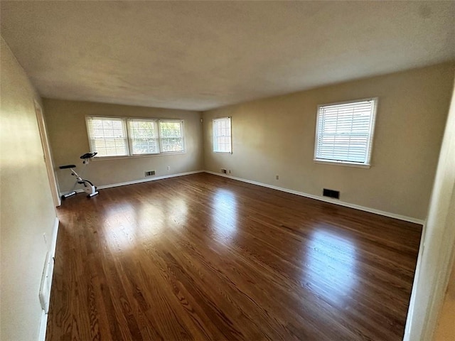 unfurnished room with dark hardwood / wood-style floors