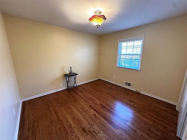 empty room featuring dark wood-type flooring