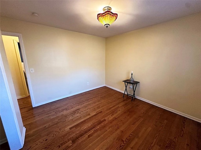 spare room with dark hardwood / wood-style flooring