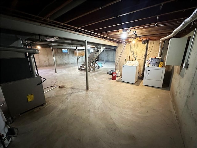 basement with heating unit and washing machine and clothes dryer