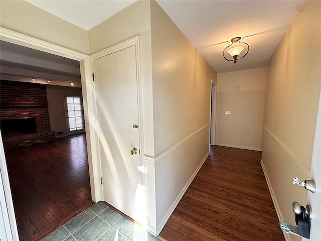 hallway with dark hardwood / wood-style flooring