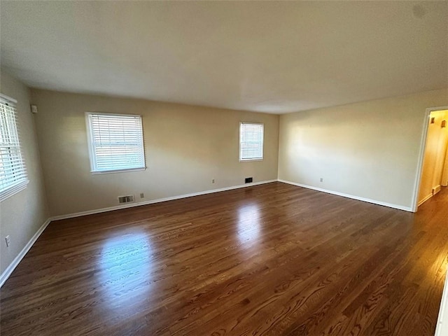 spare room featuring dark wood-type flooring