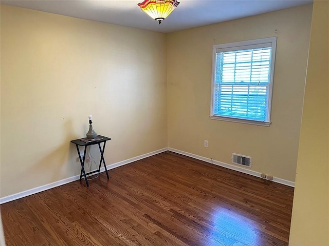 empty room with dark wood-type flooring