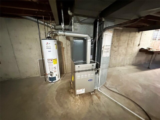 utility room featuring gas water heater and heating unit