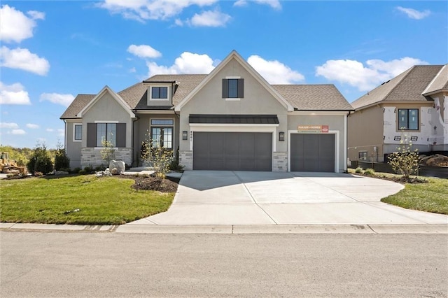 craftsman-style home with a garage and a front yard