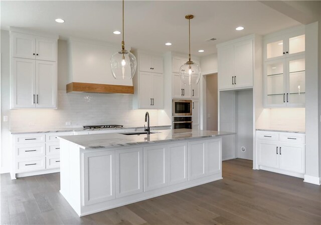 21513 W 80th Ter, Shawnee, KS 66220 - kitchen with appliances with stainless steel finishes, white cabinetry, dark wood-style floors, a kitchen island with sink, and recessed lighting