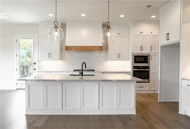 21513 W 80th Ter, Shawnee, KS 66220 - kitchen with stainless steel oven, black microwave, custom range hood, wood finished floors, and white cabinets