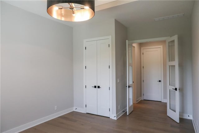 21513 W 80th Ter, Shawnee, KS 66220 - unfurnished bedroom with wood finished floors and a closet