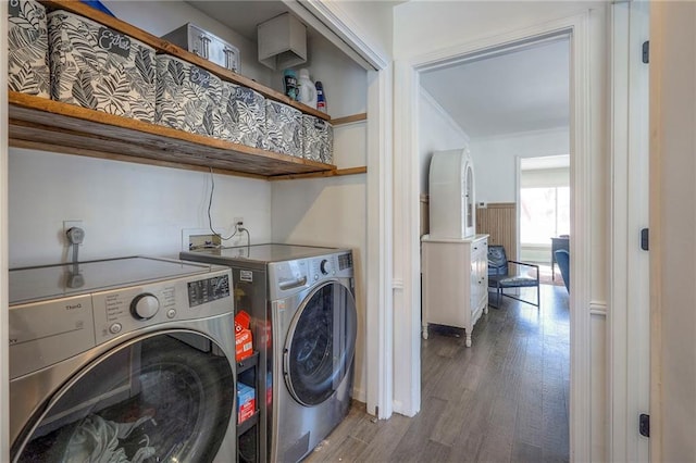 laundry area featuring washing machine and dryer, crown molding, and dark hardwood / wood-style flooring