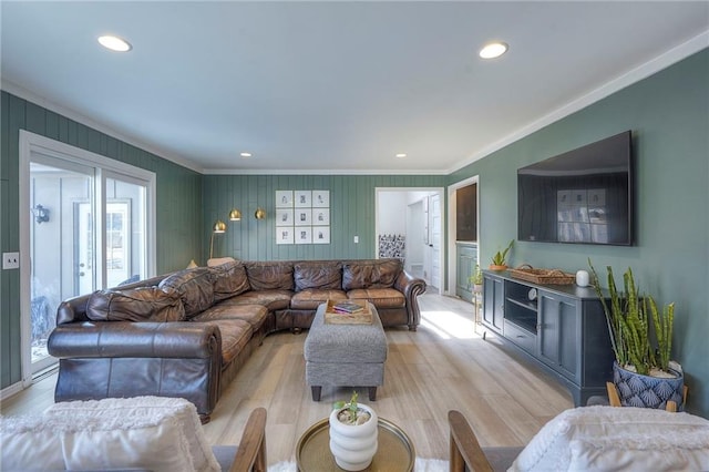 living room with crown molding and light hardwood / wood-style flooring