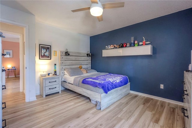 bedroom with ceiling fan and light hardwood / wood-style floors