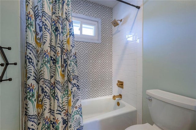 bathroom with tiled shower / bath combo and toilet