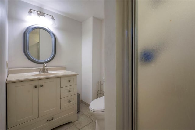 bathroom with vanity, tile patterned flooring, and toilet