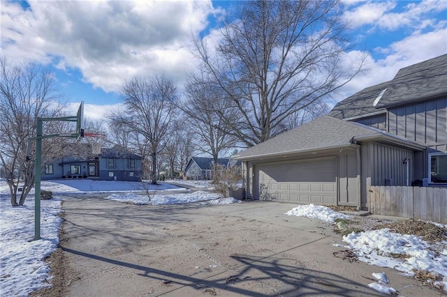 view of snow covered exterior featuring a garage