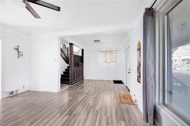 interior space with a healthy amount of sunlight, crown molding, and light hardwood / wood-style flooring