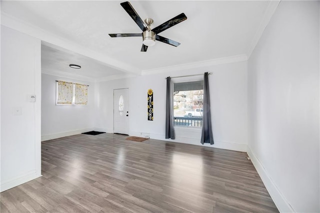 empty room with ceiling fan, crown molding, and hardwood / wood-style flooring