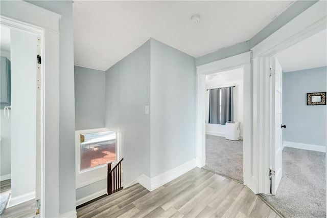 hallway with light hardwood / wood-style flooring