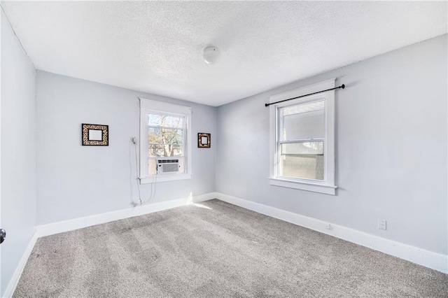 carpeted spare room featuring a textured ceiling