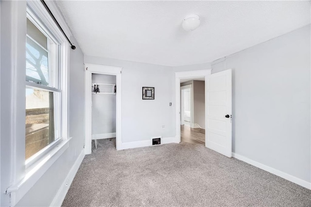 unfurnished bedroom with carpet flooring and a closet