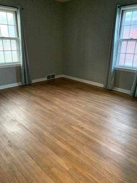 unfurnished room featuring light hardwood / wood-style flooring and plenty of natural light