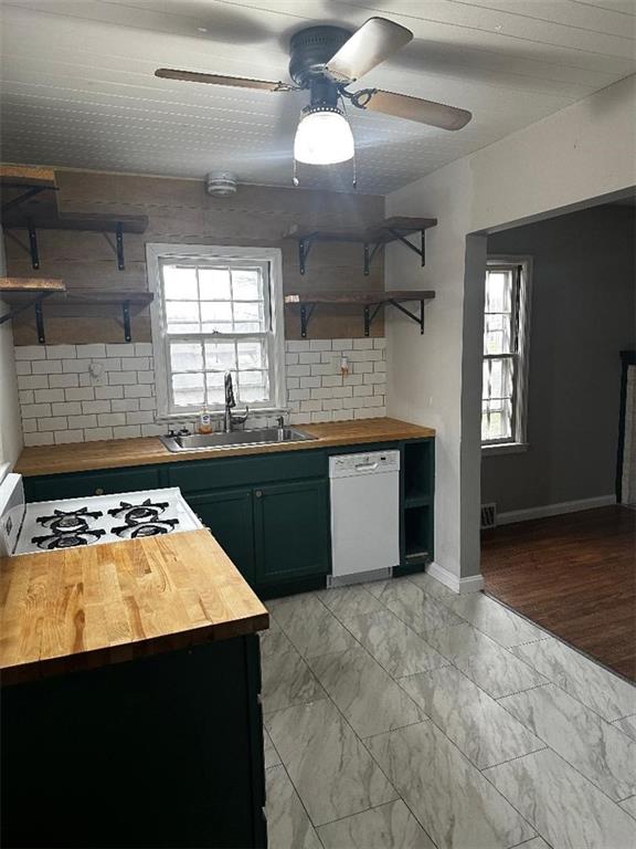 kitchen featuring wood counters, white appliances, and plenty of natural light