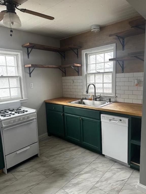 kitchen with white appliances, butcher block countertops, a healthy amount of sunlight, and sink