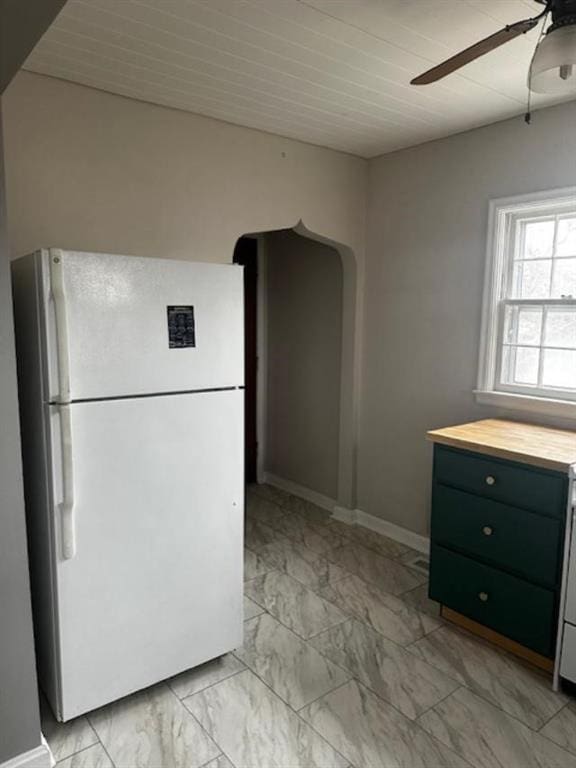 kitchen featuring ceiling fan and white fridge