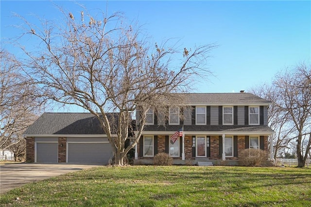 colonial house with a front yard and a garage