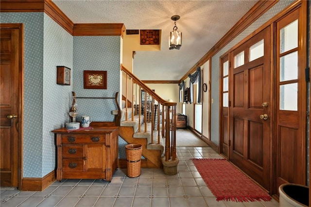 entrance foyer with a textured ceiling and ornamental molding