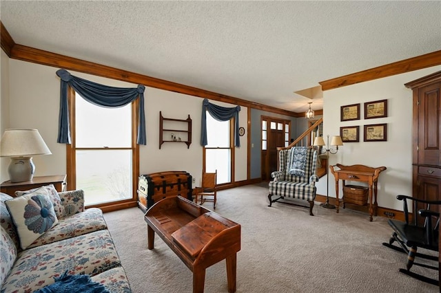 carpeted living room featuring plenty of natural light, a textured ceiling, and ornamental molding