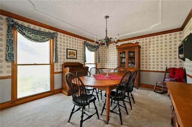 dining space featuring a chandelier, a healthy amount of sunlight, a textured ceiling, and light carpet