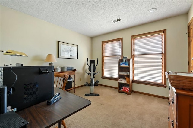 office area featuring light colored carpet and a textured ceiling