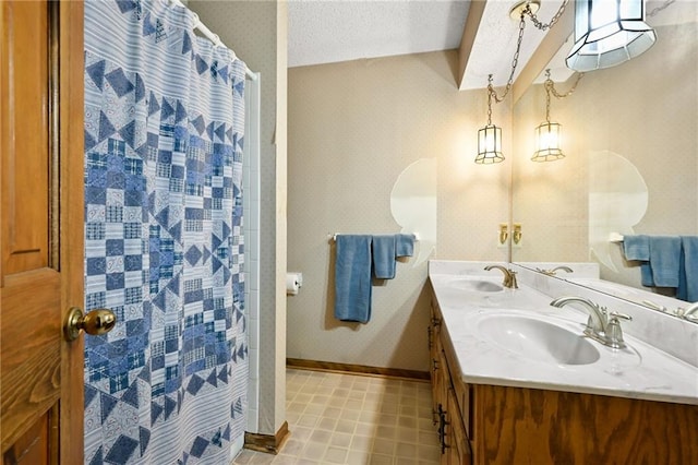 bathroom featuring vanity, a textured ceiling, and a shower with shower curtain