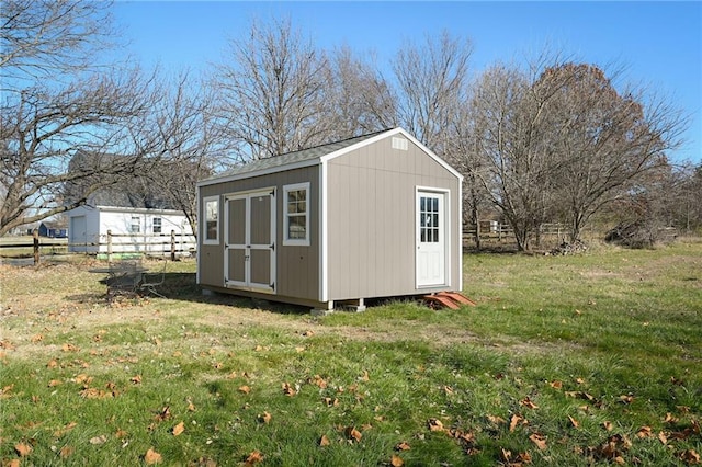 view of outbuilding with a yard